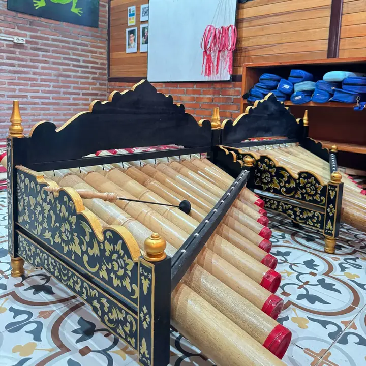 Balinese gamelan instruments in a classroom with patterned floor tiles